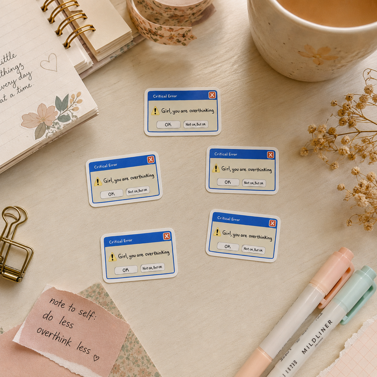 Five rectangular stickers with a blue header and white body, printed with the text 'Critical Error! Girl, you are contributing.' are arranged on a light wood desk with stationery props including a notebook, pen, markers, sticky notes, and a ceramic cup.